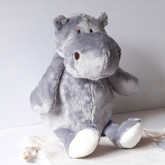 Gray plush hippo dog toy on a white background