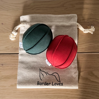 red and green play balls on top of border loves cotton gift bag