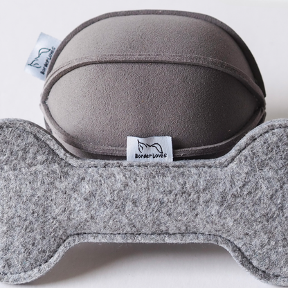 close up image of logo labels and grey indoor suede ball dog toy and grey felt rope toy by Border Loves