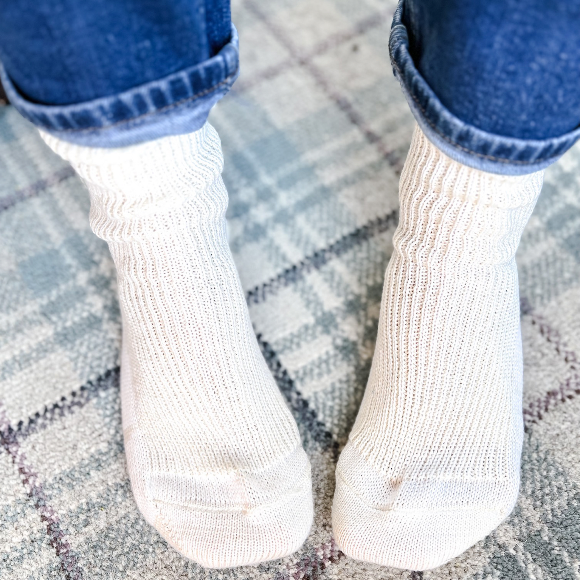 All natural no dye no bleach no synthetics socks from Border Loves shown being worn standing on carpet