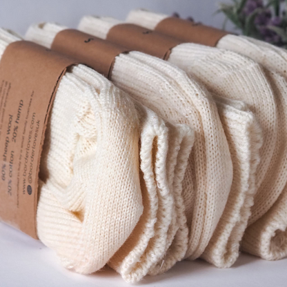 All natural luxury Socks by Border Loves lined up on their sides in their kraft label and in a row of 4